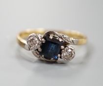 A 1960's 18ct gold, sapphire and diamond set three stone crossover ring, size M, gross weight 3