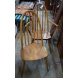 A set of six Ercol elm and beech comb back dining chairs, two with arms