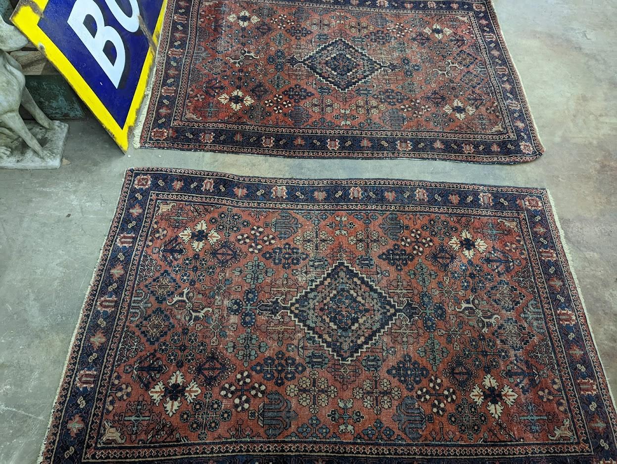 A pair of Caucasian red ground rugs, 200 x 134cm