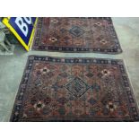 A pair of Caucasian red ground rugs, 200 x 134cm