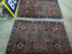 A pair of Caucasian red ground rugs, 200 x 134cm