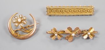 A late Victorian 15ct and seed pearl set flower and crescent brooch, 22mm, gross 3.1 grams and two