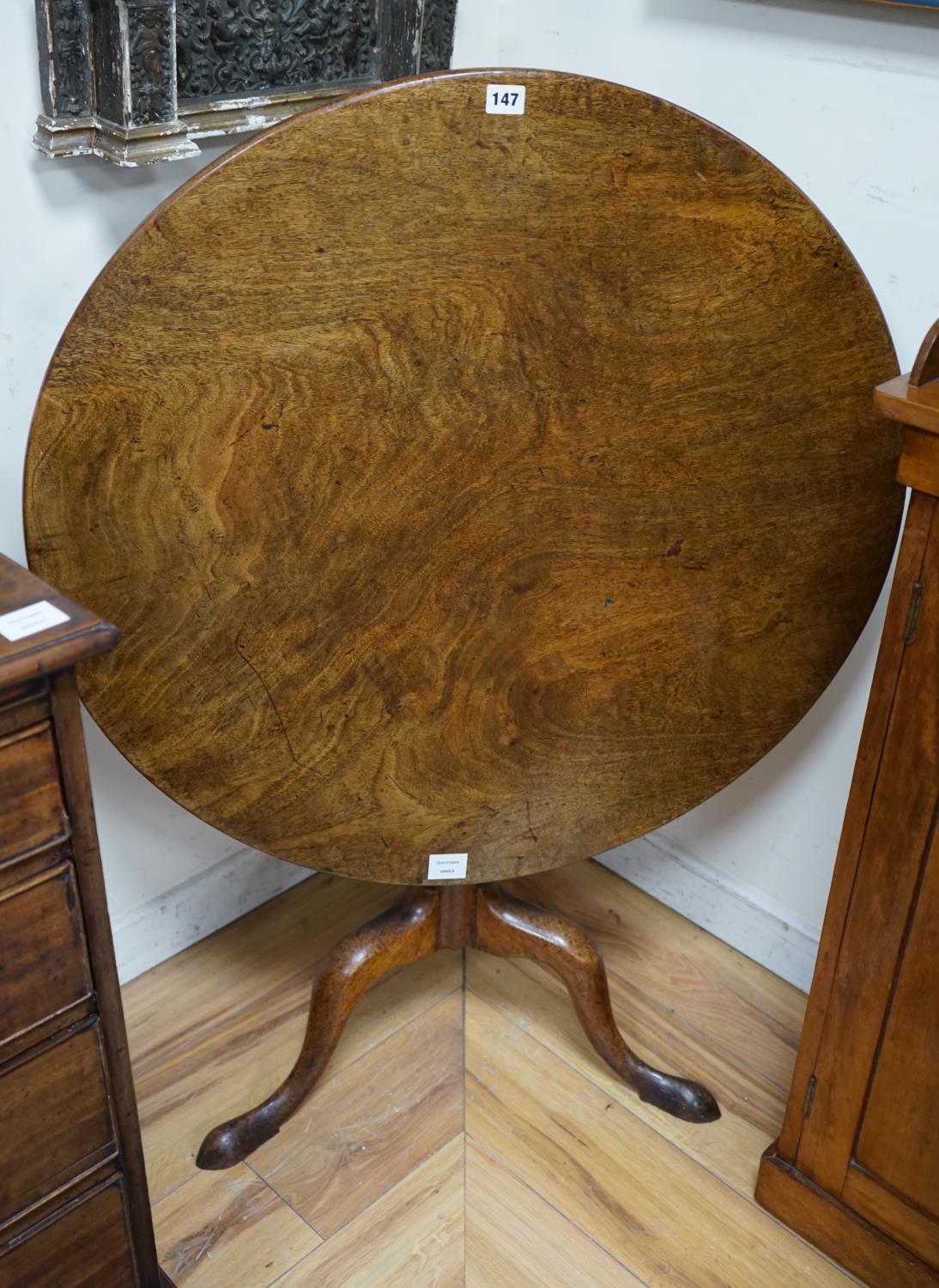 A George III circular mahogany tilt top tripod tea table, diameter 82cm height 68cm