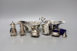 Two George V silver sauceboats, one a.f., a silver cream jug, four silver condiments, a lid and blue