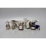 Two George V silver sauceboats, one a.f., a silver cream jug, four silver condiments, a lid and blue