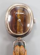 A white metal pendant watch with tiger's eye quartz dial inscribed 'Georg Jensen' overall 37mm, on a