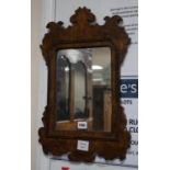 A small burr oak veneered fret cut wall mirror, width 34cm height 53cm