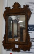 A small burr oak veneered fret cut wall mirror, width 34cm height 53cm