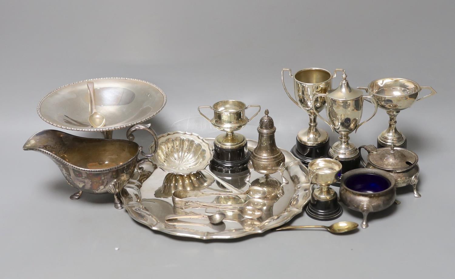 A George V silver salver, a silver tazze, a silver sauceboat, three silver condiments, a silver