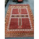 An Afghan red ground rug, 248 x 174cm