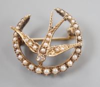 An Edwardian yellow metal, diamond and seed pearl cluster set swallow and crescent brooch, 23mm,