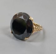 A yellow metal and facet cut hematite dress ring, size Q/R, gross weight 7.1 grams.