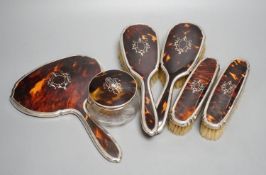 A George V silver and tortoiseshell mounted mirror and brush set, Birmingham, 1928 and a similar