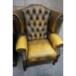 A Victorian style green leather wing armchair, width 82cm depth 76cm height 100cm