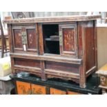 A Chinese caned pine low cabinet, width 116cm depth 48cm height 76cm