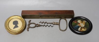 A George III framed silhouette, two corkscrews, spirit level and circular miniature painting