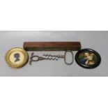 A George III framed silhouette, two corkscrews, spirit level and circular miniature painting