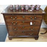 A George III mahogany chest of four graduating long drawers with brushing slide and brass handles,