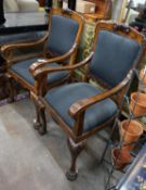 A pair of George II style burr walnut elbow chairs, on lions paw feet, width 58cm, depth 70cm,