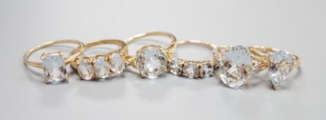 Five assorted modern 9ct gold and aquamarine set dress rings , gross 11.4 grams and one 925 ring.