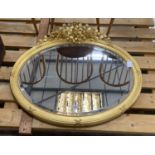 A late Victorian oval giltwood and gesso wall mirror, width 90cm, height 82cm