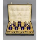 Boxed Royal Worcester blue coffee set with gilt stylised shell and swag design together with six