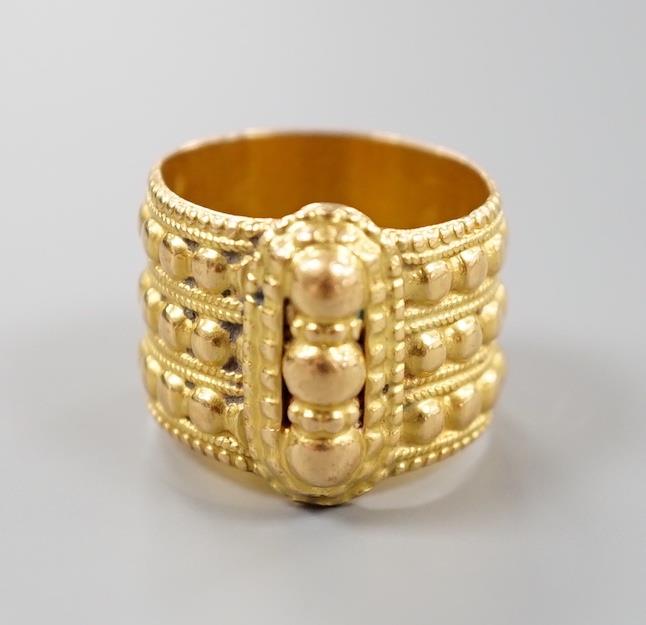 A Middle Eastern embossed yellow metal ring, size O/P, 14.8 grams.