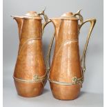 A pair of German or Austrian Jugendstil copper and brass jugs, 38cm