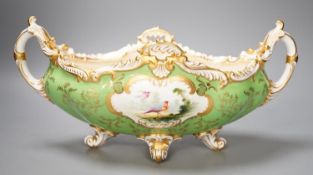 A Coalport twin handled boat shaped vase painted with a bird in panel on a lime green groundc. 1900,