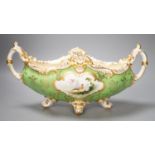 A Coalport twin handled boat shaped vase painted with a bird in panel on a lime green groundc. 1900,