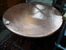 A circular hammered copper and wrought iron low table, diameter 88cm height 49cm