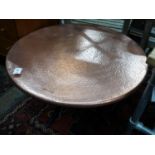 A circular hammered copper and wrought iron low table, diameter 88cm height 49cm