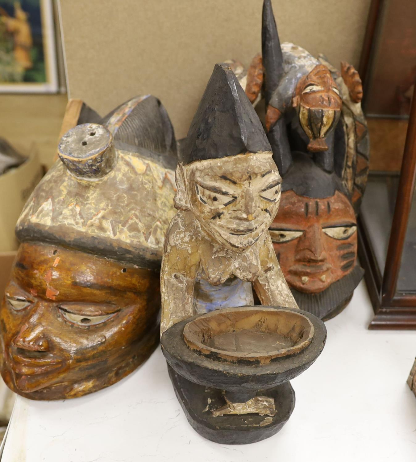 A group of West African tribal artefacts, including a Cross River Egungun mask, 48 x 20cm, a