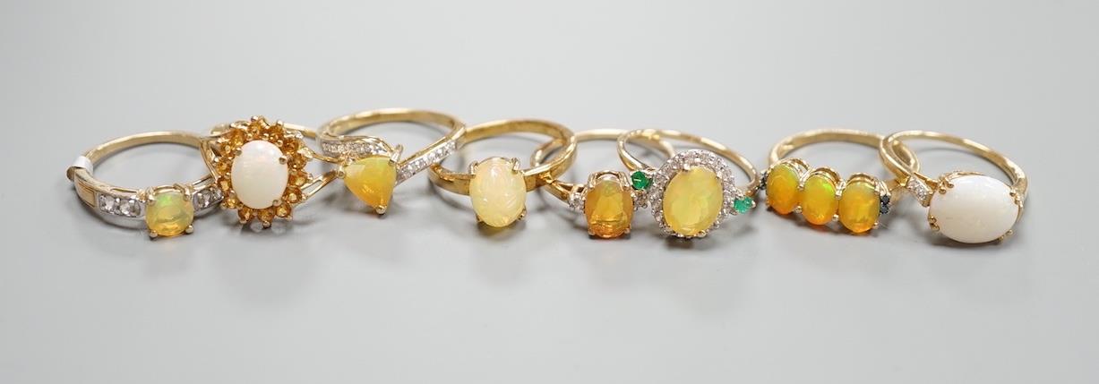 Seven assorted modern opal and gem set dress rings, gross 14.6 grams and a 925 ring.