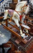 A small Ayres type dapple grey rocking horse, on safety frame, length 106cm height 96cm