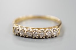 A modern 18ct gold and seven stone diamond set half hoop ring, size T/U, gross weight 3.6 grams.