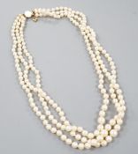 A triple strand graduated cultured pearl necklace, with yellow metal clasp, 50cm.