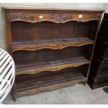 A French Provincial style walnut open bookcase, width 120cm depth 22cm height 118cm