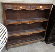 A French Provincial style walnut open bookcase, width 120cm depth 22cm height 118cm