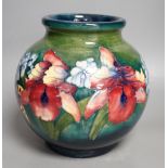 A Moorcroft green glaze 'spring flowers' squat vase,21 cms high.