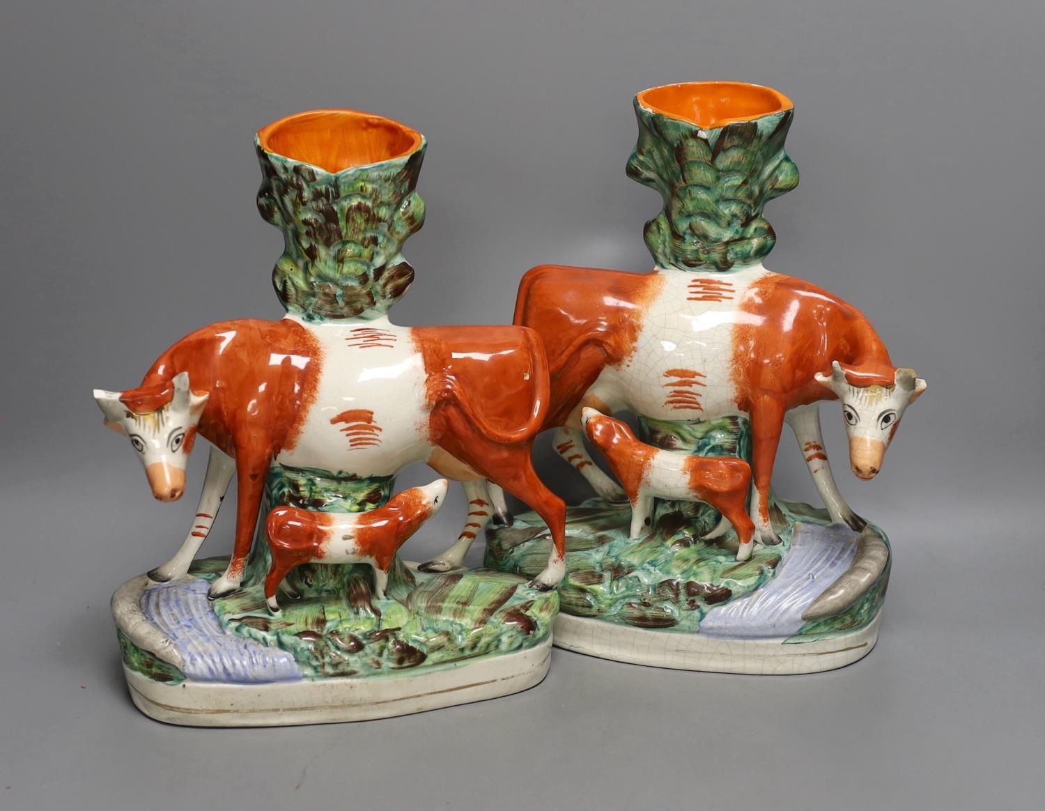 A pair of large Mid 19th century Staffordshire ‘cow and calf’ spill vases, 29cm