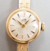 A lady's 9ct gold Tudor Royal manual wind wrist watch, on a 9ct gold bracelet with Rolex crown