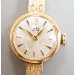 A lady's 9ct gold Tudor Royal manual wind wrist watch, on a 9ct gold bracelet with Rolex crown