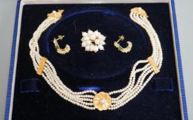 A modern cased Middle Eastern yellow metal and quintuple strand necklace, 36cm, a similar yellow