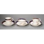 Three flight Worcester shankered teawares two coffee cup and saucers with blue borders and a teabowl