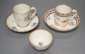 A Worcester fluted coffee cup, teacup and saucer painted with dry blue flowers and gilt foliage