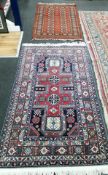 A Caucasian design blue ground rug and a Bokhara style red ground rug, 170 x 98cm and 128 x 81cm