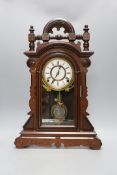 An architectural carved walnut mantel clock - 52cm tall