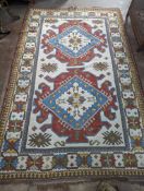 A Caucasian design ivory ground carpet, 270 x 170cm