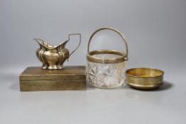 A silver cigarette box, 16.7cm, a silver cream jug, a silver mounted glass jar and a modern silver